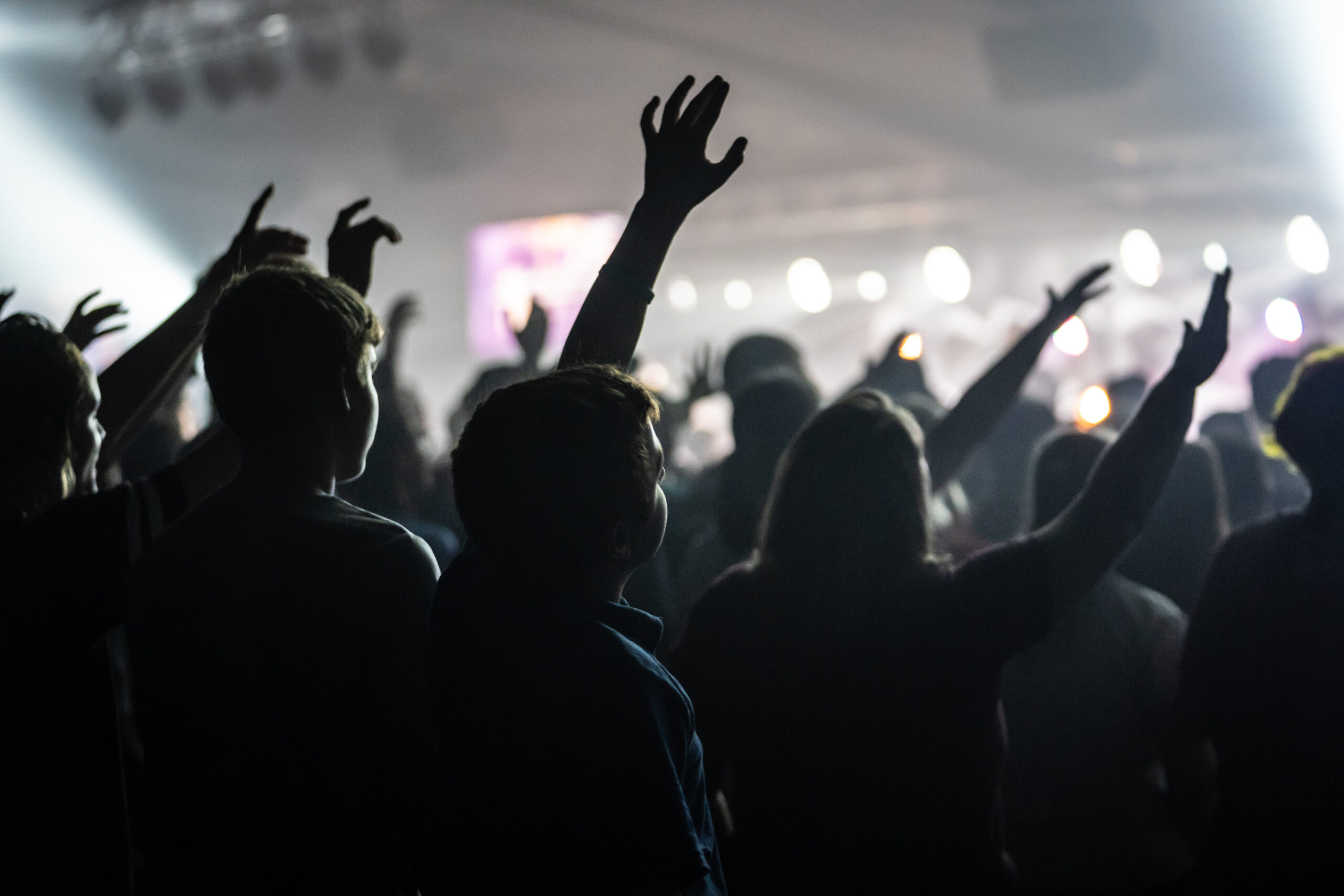 Desaturated Photo of Teenagers Worshipping Together at Camp